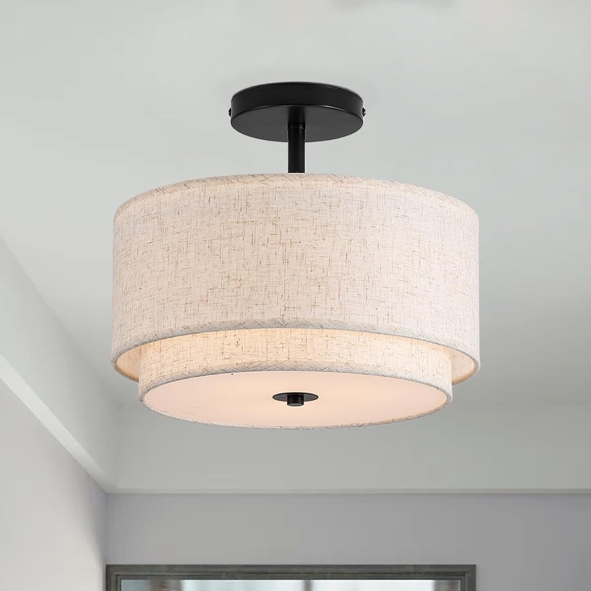 Two-layer linen drum semi-flush ceiling light with a black ceiling mount.