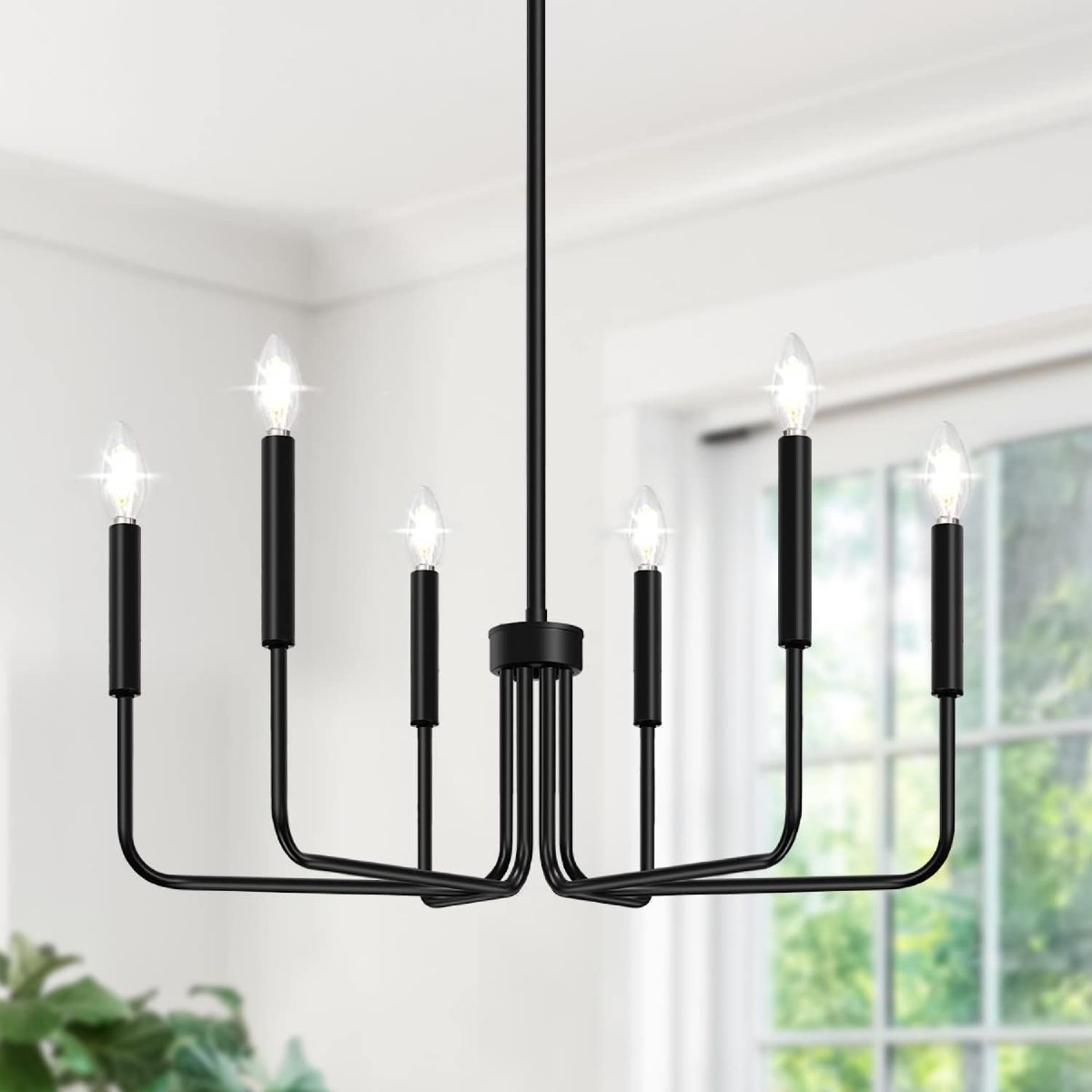 Matte black 6-light farmhouse candle chandelier with adjustable splicing rods, hanging in a bright dining room